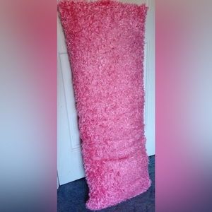 Pink homemade pillow, sunglasses vans, book, couch, angel statue